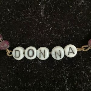 15” All About You gold‎ tone Figaro chain necklace with “Donna” spelled in beads